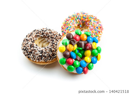 Different types of donuts with colorful toppings on a white background Different types of donuts with colorful toppings on a white background 140421518