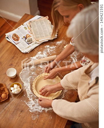 Above, people and hands baking with dough on table in kitchen and helping process in bakery. Family, prepare and press pastry in dish with flour, meal prep and work with information guide from book Above, people and hands baking with dough on table in kitchen and helping process in bakery. Family, prepare and press pastry in dish with flour, meal prep and work with information guide from book 140421591