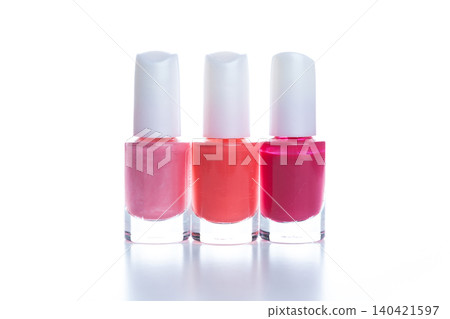 Three bottles of nail polish with different colors arranged in a line on a white background Three bottles of nail polish with different colors arranged in a line on a white background 140421597