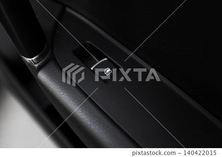 Car window control button seen inside a vehicle during a daytime drive Car window control button seen inside a vehicle during a daytime drive 140422015