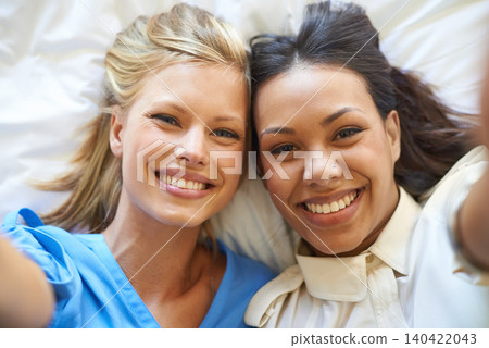 Smile, portrait and selfie of friends on bed for relax, fun or influencer post on social media. Happy, people and face of women in house for bonding, connection or memory of vacation together Smile, portrait and selfie of friends on bed for relax, fun or influencer post on social media. Happy, people and face of women in house for bonding, connection or memory of vacation together 140422043