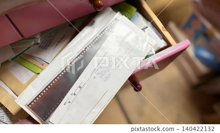 Negative film sticking out of the drawer Negative film sticking out of the drawer 140422132