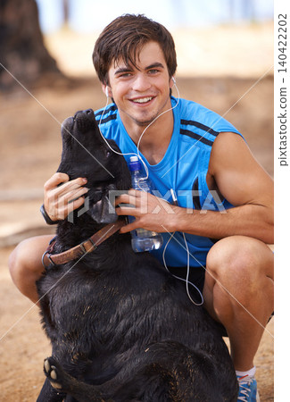 Smile, man and fitness portrait with dog on hiking trail , walking pet in nature for wellness in health. Listening, music and headphone in relaxing environment or workout, running in cardio exercise Smile, man and fitness portrait with dog on hiking trail , walking pet in nature for wellness in health. Listening, music and headphone in relaxing environment or workout, running in cardio exercise 140422202