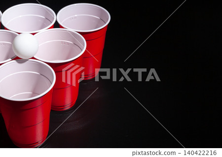 Beer pong college game on black background Beer pong college game on black background 140422216