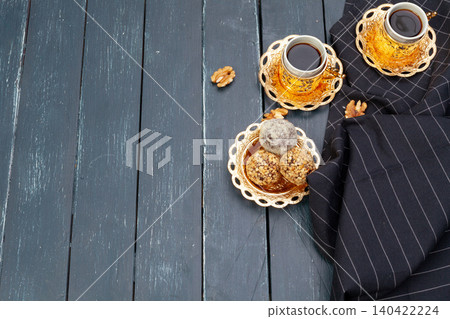 Nut balls dessert served with coffee on dark wooden table, top view Nut balls dessert served with coffee on dark wooden table, top view 140422224