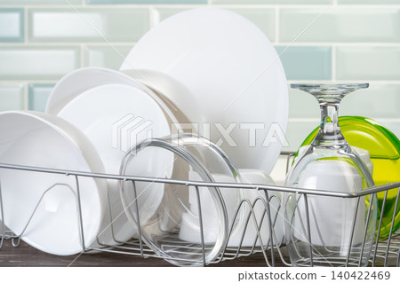 Dish rack with clean dry dishes on kitchen counter Dish rack with clean dry dishes on kitchen counter 140422469