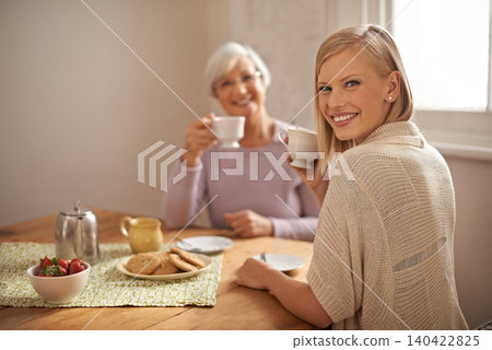 Portrait, happy woman and senior mother drinking coffee at breakfast, bonding and smile in house. Face, elderly mom and adult with tea cup at table, food and family eating cookies at home together Portrait, happy woman and senior mother drinking coffee at breakfast, bonding and smile in house. Face, elderly mom and adult with tea cup at table, food and family eating cookies at home together 140422825