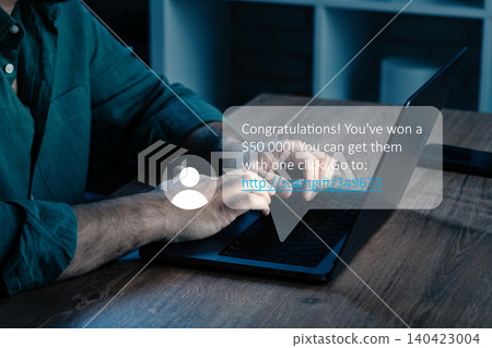 Scam message about winning money appears on a laptop screen in a home office setup Scam message about winning money appears on a laptop screen in a home office setup 140423004