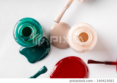 Several opened bottles of nail polish on white background Several opened bottles of nail polish on white background 140423081