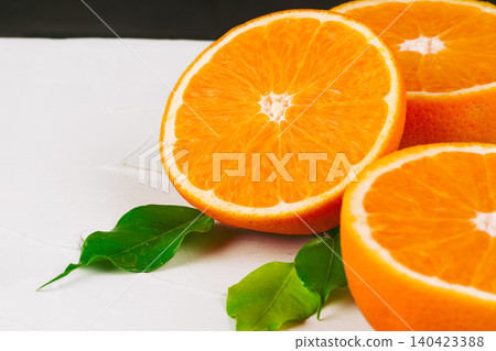 Sliced into pieces juicy ripe oranges close up Sliced into pieces juicy ripe oranges close up 140423388