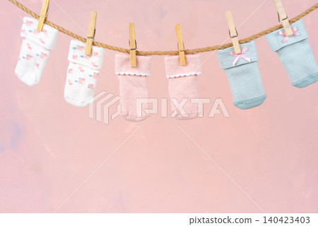 Baby socks on a clothesline. Baby clothes washing Baby socks on a clothesline. Baby clothes washing 140423403