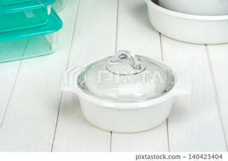 White pot cookware in a kitchen interior White pot cookware in a kitchen interior 140423404