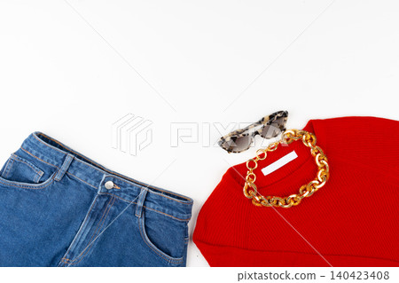 Woman outfit with red sweater and accessories on white Woman outfit with red sweater and accessories on white 140423408