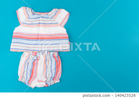 baby clothes on blue background top view baby clothes on blue background top view 140423526