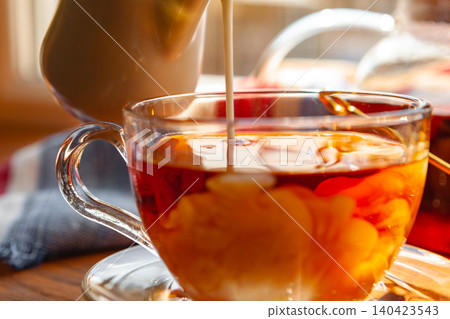 Cup of hot black tea close up on wooden table Cup of hot black tea close up on wooden table 140423543