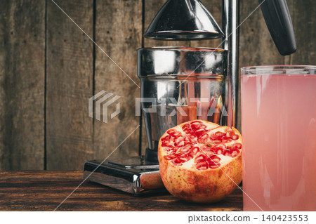 Fresh pomegranate juice on wooden table close up 140423553