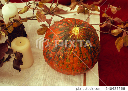 Stylish thanksgiving autumn table decor with pumpkin and dried branches 140423566