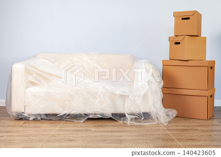 Packed household stuff in boxes and packed sofa for moving 140423605