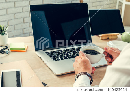 Close up of a working table of a businessman with laptop Close up of a working table of a businessman with laptop 140423624