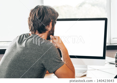 Bearded young businessman working at modern office 140423643