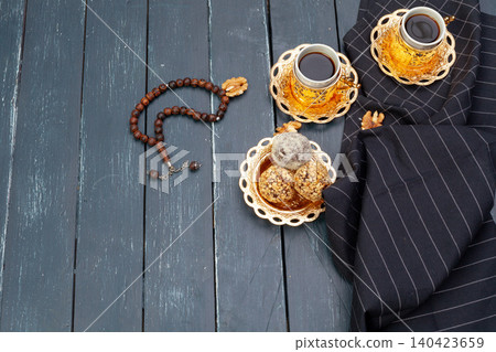 Nut balls dessert served with coffee on dark wooden table, top view 140423659