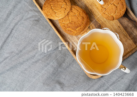White porcelain cup of tea and oat cookies on a table White porcelain cup of tea and oat cookies on a table 140423668