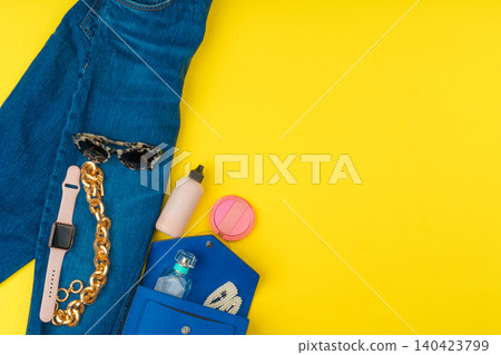 Trendy woman outfit with accessories on bright yellow background Trendy woman outfit with accessories on bright yellow background 140423799