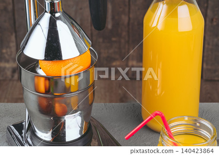 Orange juicer apparatus on kitchen table close up Orange juicer apparatus on kitchen table close up 140423864