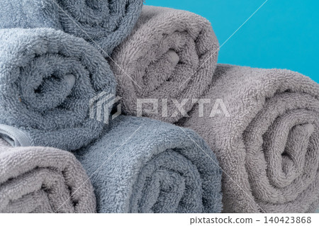 Stack of rolled towels on a wooden table 140423868