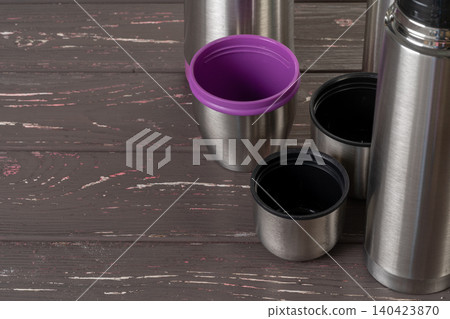 Aluminum metal thermos container bottle close up on table 140423870