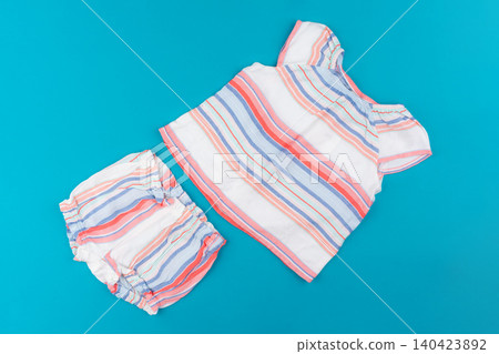 baby clothes on blue background top view baby clothes on blue background top view 140423892