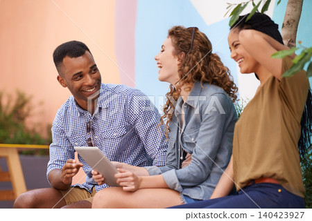 Students, outdoor and talking for collaboration on tablet, campus and scroll on social media. Friends, diversity and touchscreen at university for online academic research and happy for networking Students, outdoor and talking for collaboration on tablet, campus and scroll on social media. Friends, diversity and touchscreen at university for online academic research and happy for networking 140423927