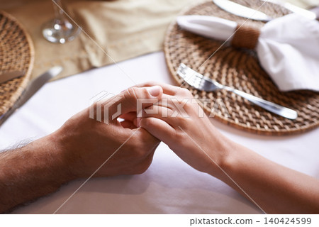 Holding hands, couple and table for support with love in restaurant for care, affection and leisure for bonding. Relationship, trust and together with committed for unity, relax and conversation. Holding hands, couple and table for support with love in restaurant for care, affection and leisure for bonding. Relationship, trust and together with committed for unity, relax and conversation. 140424599