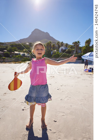 Happy girl, portrait and beach with paddle bat for playful summer, holiday weekend or outdoor ball game in nature. Female person, child or kid with smile for fun sunny day or activity by the ocean Happy girl, portrait and beach with paddle bat for playful summer, holiday weekend or outdoor ball game in nature. Female person, child or kid with smile for fun sunny day or activity by the ocean 140424748