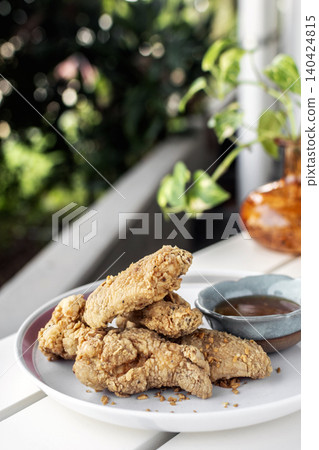crispy breaded deep fried chicken pieces snack on white table in outdoor cafe crispy breaded deep fried chicken pieces snack on white table in outdoor cafe 140424815