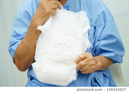 Asian senior woman patient wearing adult incontinence diaper pad in hospital. Asian senior woman patient wearing adult incontinence diaper pad in hospital. 140424837