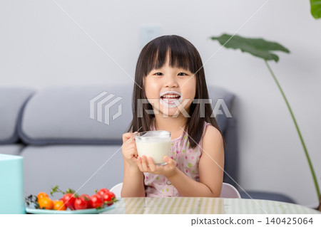 Happy Asian little girl drinking milk, healthy nutrition and calcium intake concept Happy Asian little girl drinking milk, healthy nutrition and calcium intake concept 140425064