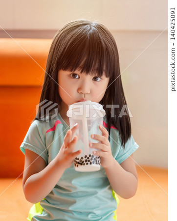 Asian little girl drinking bubble tea, sugary drink and unhealthy eating habit concept 140425091