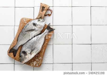 Fresh raw dorado fish cooking with ingredients. Sea bream, dorado. Seafood, healthy food. Top view Fresh raw dorado fish cooking with ingredients. Sea bream, dorado. Seafood, healthy food. Top view 140425199