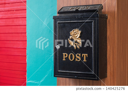 Black post mailbox on colorful wall vibrant urban composition Black post mailbox on colorful wall vibrant urban composition 140425276