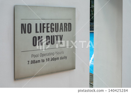 No lifeguard on duty sign near swimming pool with operating hours displayed No lifeguard on duty sign near swimming pool with operating hours displayed 140425284