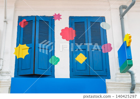Blue wooden shutters on historic building with colorful decorations Blue wooden shutters on historic building with colorful decorations 140425297