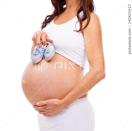 Woman, pregnant and studio with baby shoes, maternity and confidence with care. Mother, proud and pregnancy with belly, child and stomach for positive parenting and motherhood on white background Woman, pregnant and studio with baby shoes, maternity and confidence with care. Mother, proud and pregnancy with belly, child and stomach for positive parenting and motherhood on white background 140425417