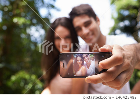 Couple, selfie and phone screen for hiking in forest with smile for memory, post and web blog. Man, woman and profile picture for trekking, direction and jungle on app for social media in Colombia 140425482