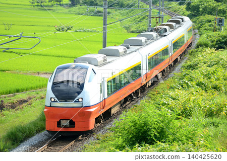 The Tsugaru Limited Express train runs through the countryside. The Tsugaru Limited Express train runs through the countryside. 140425620