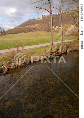 Countryside River Landscape With Castle Ruins on Hill Countryside River Landscape With Castle Ruins on Hill 140425691