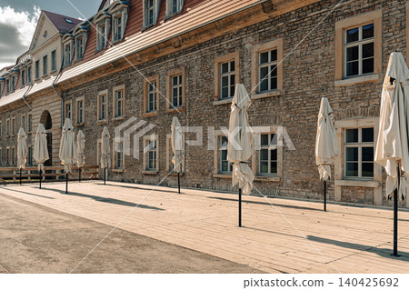 Erfurt, Germany - March 27, 2026. Historic Stone Building With Terrace Umbrellas Erfurt, Germany - March 27, 2026. Historic Stone Building With Terrace Umbrellas 140425692