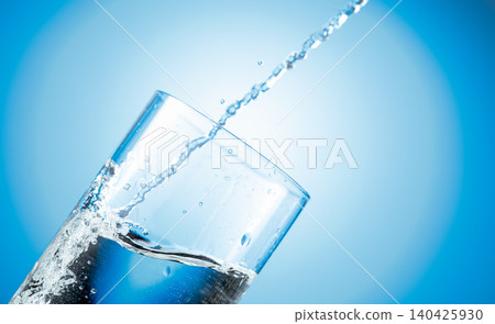 Clear drinking carbonated water pouring into a tall glass. Clear drinking carbonated water pouring into a tall glass. 140425930