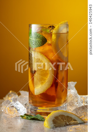 Iced tea in a misted glass on a stone table. Iced tea in a misted glass on a stone table. 140425943