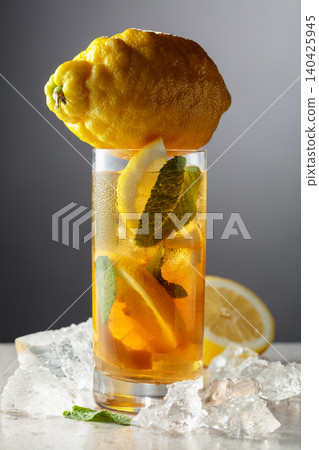 Iced tea in a misted glass on a stone table. Iced tea in a misted glass on a stone table. 140425945
